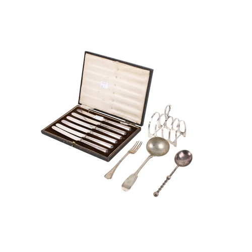 43 - A small group of silver and white metal table items. Comprising a set of six silver handled butter k... 