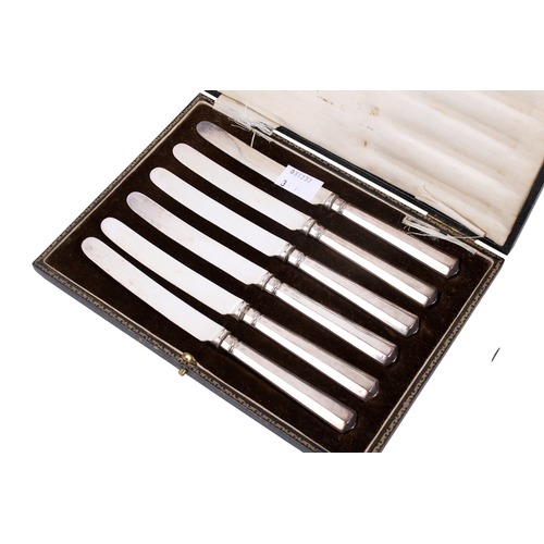 43 - A small group of silver and white metal table items. Comprising a set of six silver handled butter k... 