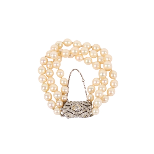 241 - A vintage faux pearl three-string bracelet. With an ornate silver and paste clasp, marked sterlg, th... 