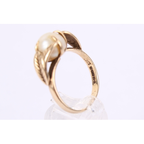 254 - A 9ct gold and pearl dress ring. The pearl of circa 8mm diameter, with a flattened base, in a hallma... 