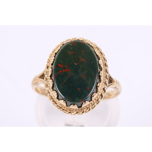 256 - A 9ct gold nad bloddstone ring. The oval of circa 1.4cm x 0.9cm, in a filigree setting, hallmarked t... 