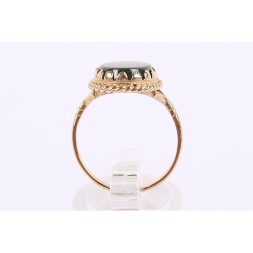 256 - A 9ct gold nad bloddstone ring. The oval of circa 1.4cm x 0.9cm, in a filigree setting, hallmarked t... 