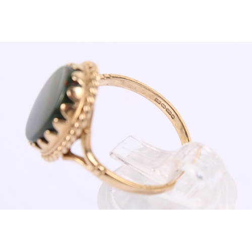 256 - A 9ct gold nad bloddstone ring. The oval of circa 1.4cm x 0.9cm, in a filigree setting, hallmarked t... 