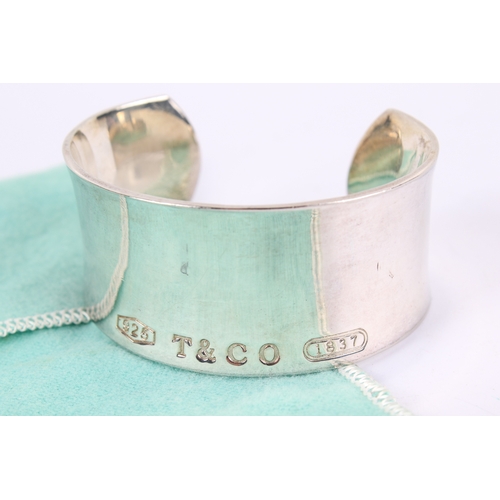 259 - A silver 1837 Tiffany style silver cuff. Marked 925 T&Co 1837 to the outside, and with copyright mar... 