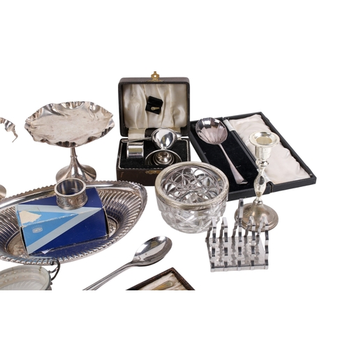293 - A collection of silverplated table items. Including candlesticks, a boxed egg and spoon set, dishes,... 
