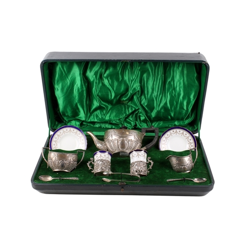 26 - An early 20th century matched silver tea set. The teapot, milk jug and sugar bowl decorated with rib... 