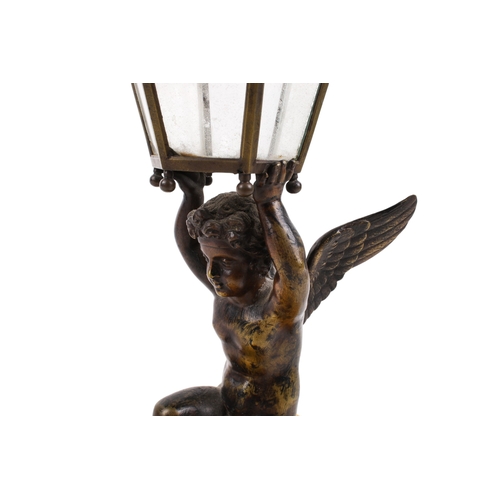 239 - An early 20th century figural table lamp. Modelled as a bronze cherub in a kneeling pose, holding a ... 
