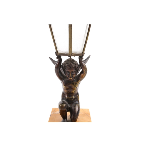 239 - An early 20th century figural table lamp. Modelled as a bronze cherub in a kneeling pose, holding a ... 