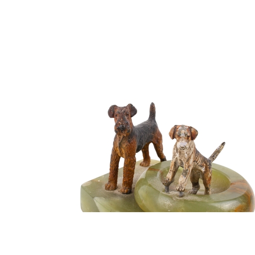 243 - Two 20th century onyx pin trays with painted cast metal dogs, in the style of Bergman. One of circul... 