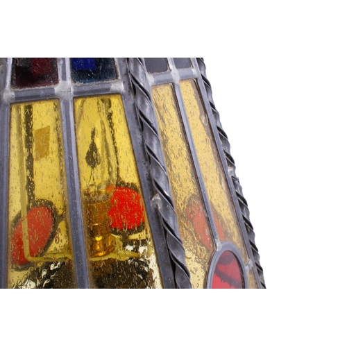 251 - A vintage brass table lamp. The hexagonal shade of tapered form, constructed of leaded red and orang... 