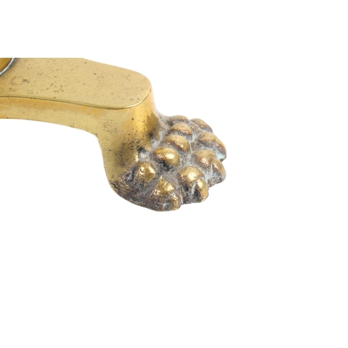 257 - A Victorian brass trivet. The circular top with pierced decoration and a shaped edge, mounted on a s... 