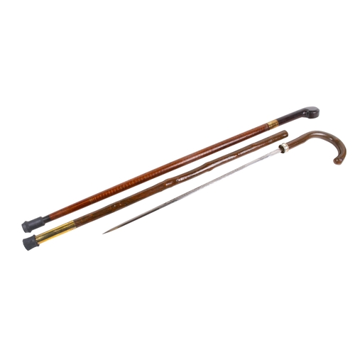 294 - Two sword sticks. The one having a stained mahogany hilt, brass mount and engraved blade, the wooden... 