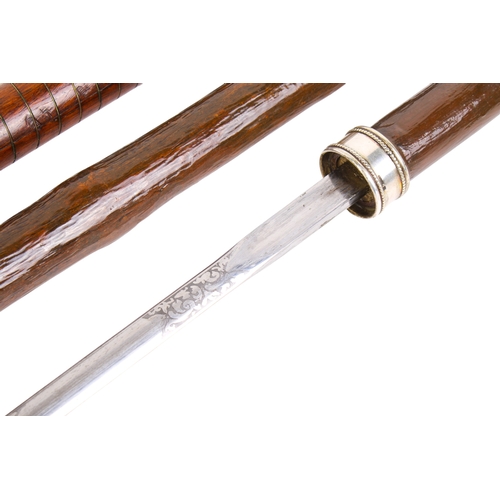 294 - Two sword sticks. The one having a stained mahogany hilt, brass mount and engraved blade, the wooden... 