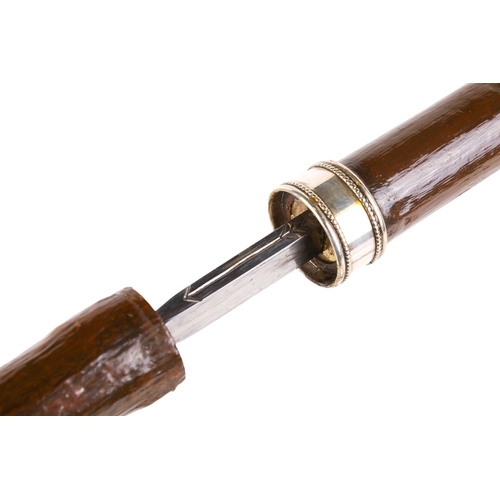 294 - Two sword sticks. The one having a stained mahogany hilt, brass mount and engraved blade, the wooden... 