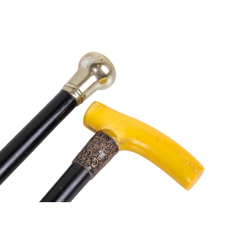294A - Two white metal mounted and ebonized walking sticks and a similar swagger stick. The swagger stick h... 