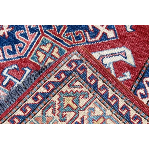 451 - A flat weave red, blue and cream rug. With zoomorphic patterns on a rust-red ground, 187cm x 133cm.