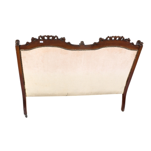 441 - A Regency style two seater sofa. Having carved ribbon and leaf decoration, raised on tapering fluted... 