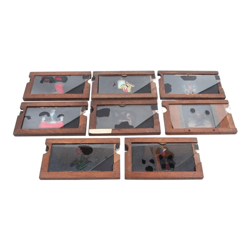 118 - Eight wood-framed hand-coloured double-slipper animated moving Magic Lantern Slides. Two stamped 'Ne... 
