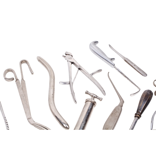 152 - A collection of medical and surgical tools. To include a syringe, a Trocar, and clamps with Broad Ar... 