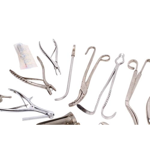152 - A collection of medical and surgical tools. To include a syringe, a Trocar, and clamps with Broad Ar... 