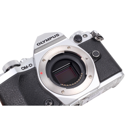 72 - An Olympus OM-D E-M5II Mirrorless Digital camera. Powers on, shutter working. With a Lumix G 45-175m... 