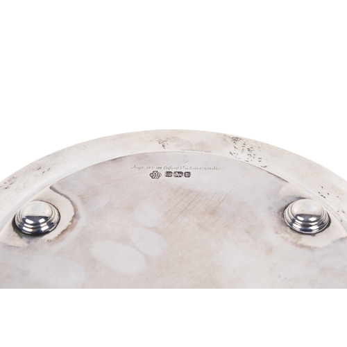 13 - An early 20th century round silver salver. Decorated with swags of flowers and hanging baskets, rais... 