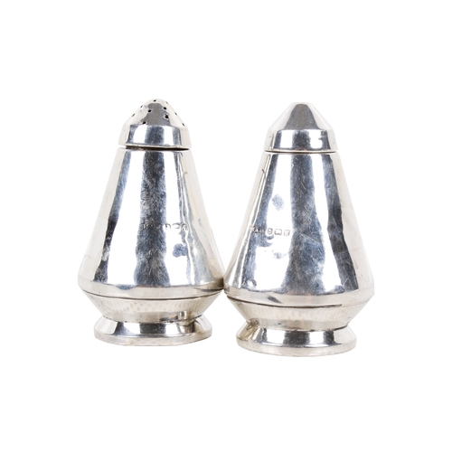 62 - A 20th century silver 'space rocket' salt and pepper set. Of tapered form with circular weighted bas... 