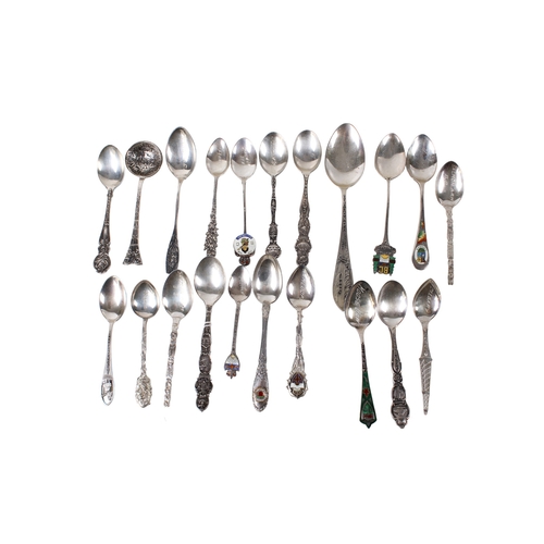 69 - A collection of white metal teaspoons. The handles decorated with embossed flowers, architecture and... 