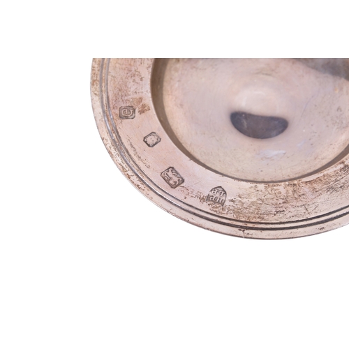 71 - A small 20th century silver coin dish and a Victorian silver sugar sifter. The coin dish having a ri... 