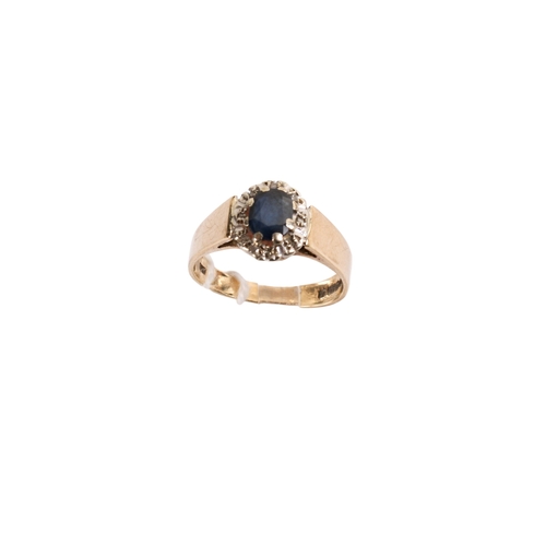 164 - A 9ct gold and sapphire dress ring. The oval faceted stone circa 5mm x 4mm surrounded by tiny diamon... 