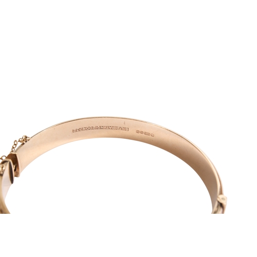 197 - A 9ct gold bangle and a rolled gold example. With matching engraved design to one half, both with se... 