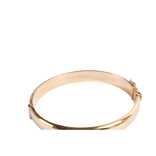 197 - A 9ct gold bangle and a rolled gold example. With matching engraved design to one half, both with se... 