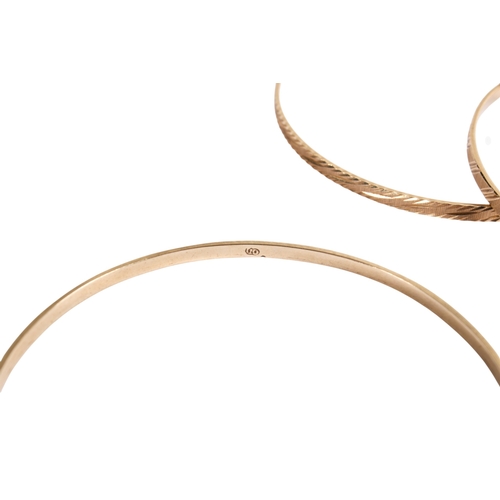 198 - Seven 9ct gold (tested) narrow flat bangles of various designs, some marked. Gross weight 49.8g.