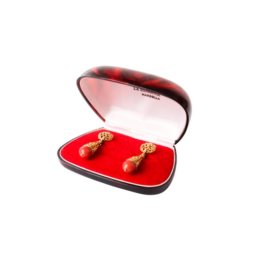 301 - A pair of drop earrings, each with a coral bead termination. Metal not marked, acid testing indicati... 