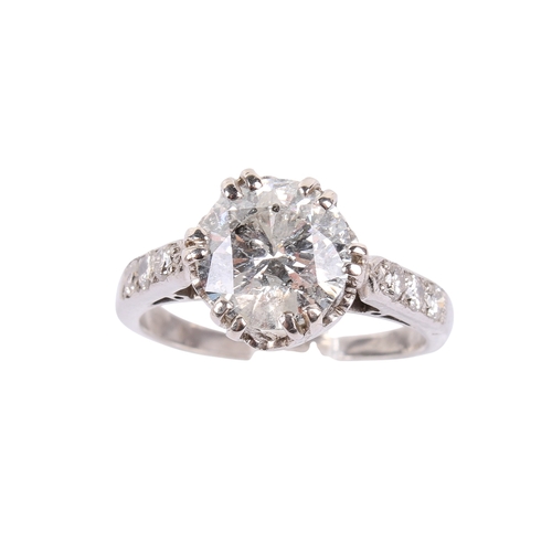 93 - A white metal and diamond ring. Set centrally with one round brilliant cut diamond of approximately ... 