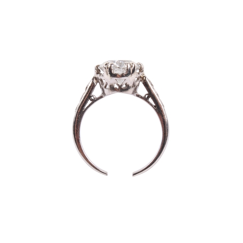 93 - A white metal and diamond ring. Set centrally with one round brilliant cut diamond of approximately ... 