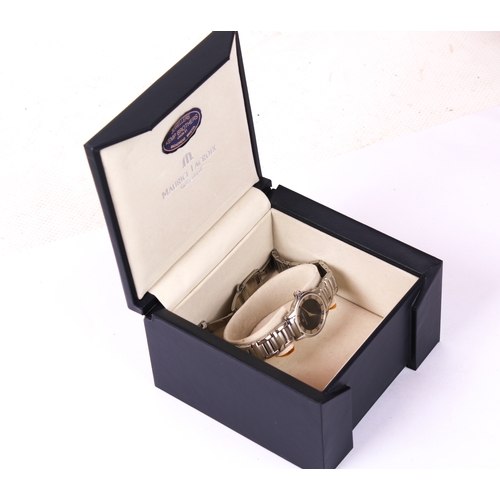 387 - A lady's Maurice Lacroix wristwatch. The black dial surrounded by a stainless steel bezel with Roman... 