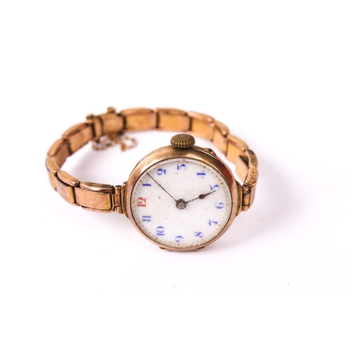 395 - A 9ct gold ladies wristwatch. The white enamel dial with blue and red Arabic numerals, in a 9ct gold... 