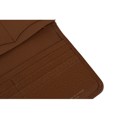 472 - A Smythson of Bond Street tan leather purse. Having a crossgrain leather exterior and chrome sliding... 