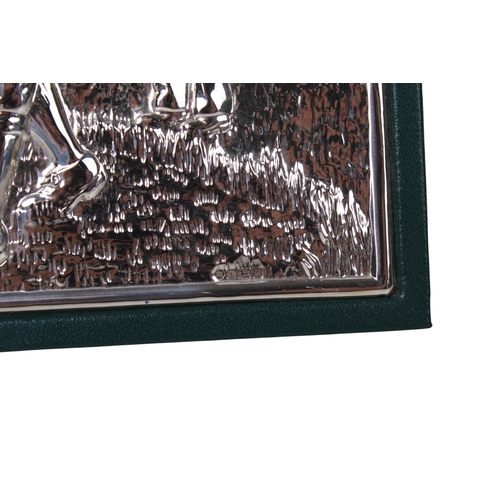 A silver fronted golfing record book. With repoussé silver front panel ...