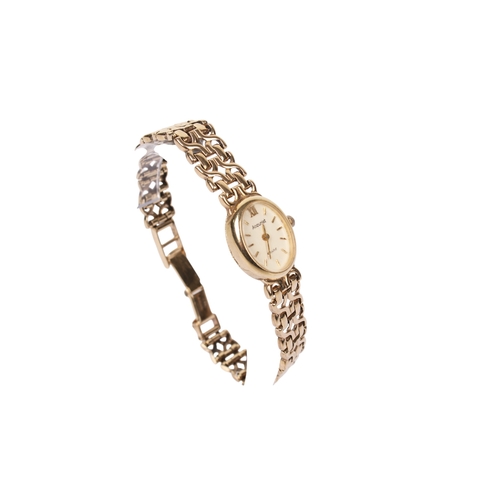 363 - A lady's 9ct gold Accurist wristwatch. The oval case having a champagne dial with baton hour markers... 