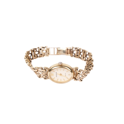 363 - A lady's 9ct gold Accurist wristwatch. The oval case having a champagne dial with baton hour markers... 