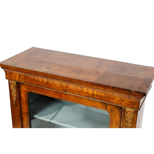 391 - A 19th century inlaid mahogany pier cabinet. Having a glazed door opening to reveal two fixed shelve... 