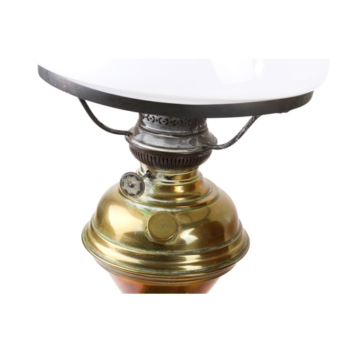 397 - A helmet shaped copper coal skuttle and a brass oil lamp. Max. H52cm