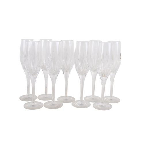 428 - A set of nine Stuart glass champagne flutes. H23cm