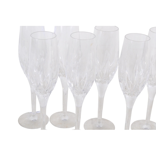 428 - A set of nine Stuart glass champagne flutes. H23cm