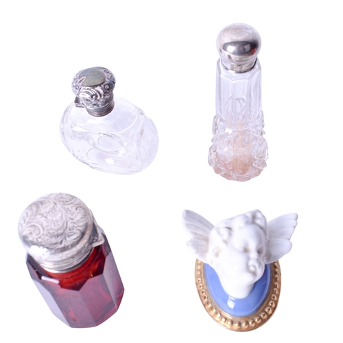 141 - A collection of vintage scent bottles and costume jewellery. The red and colourless cut glass bottle... 