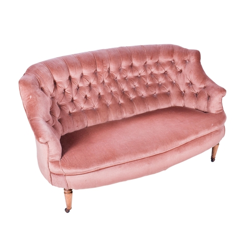 158 - A 20th century curved wingback sofa. Upholstered in pink fabric with a button back, raised on wooden... 