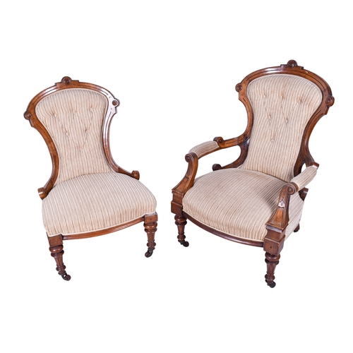 159 - A pair of 20th century chairs. Comprising an armchair and a nursing chair, both with carved wooden f... 