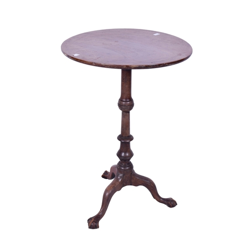 160 - An early 20th century mahogany wine table. The circular top mounted on a turned and tapered stand te... 